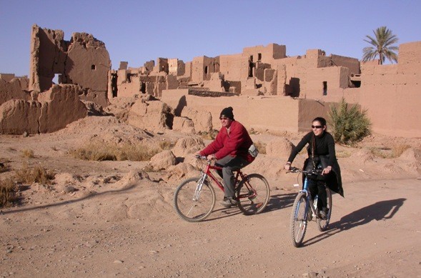 Paseo en bicicleta ante el ksar Asrir, oasis de Ferkla.